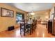 Elegant dining room with hardwood floors, a large table, and a decorative light fixture, perfect for entertaining at 4901 W 103Rd Cir, Westminster, CO 80031