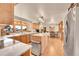 Modern kitchen with an island and barstool seating, quartz countertops, and stainless appliances provides plenty of work space at 4901 W 103Rd Cir, Westminster, CO 80031