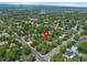 Aerial view pinpointing a home nestled among mature trees in a peaceful, established neighborhood at 6283 S Prescott St, Littleton, CO 80120