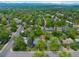 Aerial view showcasing a property with lush greenery and surrounding neighborhood at 6283 S Prescott St, Littleton, CO 80120