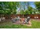 Cozy backyard with a fire pit and seating area, surrounded by lush greenery and a wooden fence at 6283 S Prescott St, Littleton, CO 80120