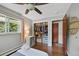 Bright bedroom featuring hardwood floors, open closet with organizers, and a sunlit window at 6283 S Prescott St, Littleton, CO 80120
