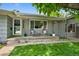 Charming front porch with seating, well-manicured lawn, and inviting curb appeal at 6283 S Prescott St, Littleton, CO 80120