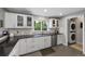 Bright kitchen with white cabinetry, dark countertops, and stainless steel appliances at 6283 S Prescott St, Littleton, CO 80120