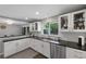 Updated kitchen with white cabinets, stainless appliances, and dark countertops at 6283 S Prescott St, Littleton, CO 80120