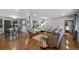 Open living room with wood floors and abundant natural light; view to kitchen at 6283 S Prescott St, Littleton, CO 80120
