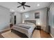 Comfortable main bedroom with a ceiling fan, ample natural light, and an ensuite bathroom for convenience at 6283 S Prescott St, Littleton, CO 80120