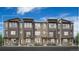 Modern townhome exterior featuring stone accents, dark trim, large windows, and inviting entrance doors at 6295 N Kirk St, Aurora, CO 80019
