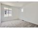 Bright bedroom with neutral carpet, white walls, and two windows offering natural light at 683 N Deer Park St, Watkins, CO 80137
