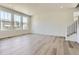 Bright, open living room with hardwood floors, large windows, and plenty of natural light at 683 N Deer Park St, Watkins, CO 80137
