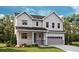 Charming two-story home with neutral siding, manicured lawn, and attached two-car garage in a serene community at 661 Split Rock Dr, Erie, CO 80516