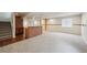 Finished basement features carpet, exposed brick, and wood shelving at 1623 E 164Th Pl, Brighton, CO 80602