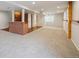 Finished basement features carpet, exposed brick, and wood shelving at 1623 E 164Th Pl, Brighton, CO 80602