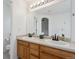 Bright bathroom featuring double sinks, a large mirror, and white countertops in a neutral color scheme at 1623 E 164Th Pl, Brighton, CO 80602