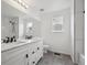 Bathroom with dual vanity, white cabinets, and black fixtures with black and white tile at 1623 E 164Th Pl, Brighton, CO 80602