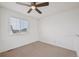 White bedroom features a window with blinds, neutral carpet, and ceiling fan at 1623 E 164Th Pl, Brighton, CO 80602