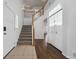 Entryway with ceramic tile, closet, hardwood flooring and a staircase leading upstairs at 1623 E 164Th Pl, Brighton, CO 80602