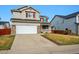 Two-story home with gray siding, brick accents and a driveway at 1623 E 164Th Pl, Brighton, CO 80602