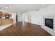 Open-concept living room featuring wood floors and a decorative fireplace at 1623 E 164Th Pl, Brighton, CO 80602