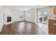 Living room featuring wood floors, fireplace, and sliding glass door to a porch at 1623 E 164Th Pl, Brighton, CO 80602