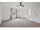 Spacious main bedroom featuring neutral carpeting, a ceiling fan, natural lighting, and ensuite access at 1623 E 164Th Pl, Brighton, CO 80602