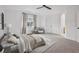 Spacious main bedroom featuring neutral carpeting, a ceiling fan, natural lighting, and ensuite access at 1623 E 164Th Pl, Brighton, CO 80602