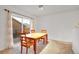 Bright dining area with natural light, wood table, and seating for four at 23317 E Saratoga Cir, Aurora, CO 80016