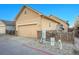 Beige townhouse featuring an attached garage, and a cozy backyard area with privacy fence at 23317 E Saratoga Cir, Aurora, CO 80016