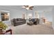 Spacious living room with neutral carpet, ceiling fan, and plenty of natural light at 23317 E Saratoga Cir, Aurora, CO 80016