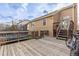 Wooden back deck with stairs leading to yard with trampoline and bike at 4334 Lisbon St, Denver, CO 80249