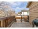 Wooden back deck overlooking backyard, with stairs leading down to the yard at 4334 Lisbon St, Denver, CO 80249