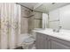 Bright bathroom featuring a shower over tub, mosaic tile accent, and a gray vanity at 4334 Lisbon St, Denver, CO 80249