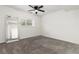 A neutral bedroom with a large mirror and a window at 4334 Lisbon St, Denver, CO 80249