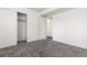 Well-lit bedroom featuring a closet with sliding doors and neutral carpet at 4334 Lisbon St, Denver, CO 80249