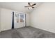 A neutral bedroom with a vaulted ceiling and a ceiling fan at 4334 Lisbon St, Denver, CO 80249