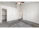 Spacious bedroom with neutral carpet, a ceiling fan, and ample closet space at 4334 Lisbon St, Denver, CO 80249