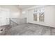 Bonus room with neutral walls, plush carpeting, natural light, and open floor plan at 4334 Lisbon St, Denver, CO 80249