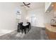 Inviting dining area with large windows, a ceiling fan, and neutral colors at 4334 Lisbon St, Denver, CO 80249