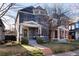 Two-story home with a landscaped front yard, covered front porch, and attractive curb appeal in an established neighborhood at 713 S Washington St, Denver, CO 80209