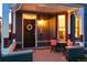 Charming front porch with decorative columns, a wrought iron table set, and an inviting wreath on the front door at 713 S Washington St, Denver, CO 80209