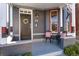 Quaint front porch with outdoor seating, a decorative wreath, and eye-catching architectural details on a well-maintained home at 713 S Washington St, Denver, CO 80209