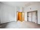 Neutral bedroom features an open closet, and multiple bathroom and bedroom door entrances at 14231 E Dickinson Dr # E, Aurora, CO 80014