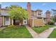 Charming townhome with a brick chimney and a well-maintained front yard at 14231 E Dickinson Dr # E, Aurora, CO 80014
