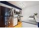 Modern kitchen features stainless steel appliances, white cabinetry, and sleek countertops at 14231 E Dickinson Dr # E, Aurora, CO 80014