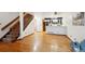 Open-concept living room featuring hardwood floors, staircase, and view of the kitchen at 14231 E Dickinson Dr # E, Aurora, CO 80014
