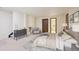 Comfortable main bedroom featuring a spacious layout, gray dresser, chair, and ensuite bathroom access at 14231 E Dickinson Dr # E, Aurora, CO 80014