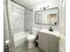 Clean bathroom with gray tile and modern vanity at 2683 S Carson Way, Aurora, CO 80014