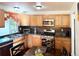 Eat-in kitchen with stainless steel appliances and wood cabinets at 2683 S Carson Way, Aurora, CO 80014