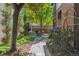 Beautiful backyard with lush greenery, mature trees, and a stone pathway at 536 N Williams St, Denver, CO 80218