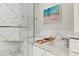 Luxurious bathroom featuring a soaking tub with marble surround, a glass enclosed shower, and stylish fixtures at 536 N Williams St, Denver, CO 80218